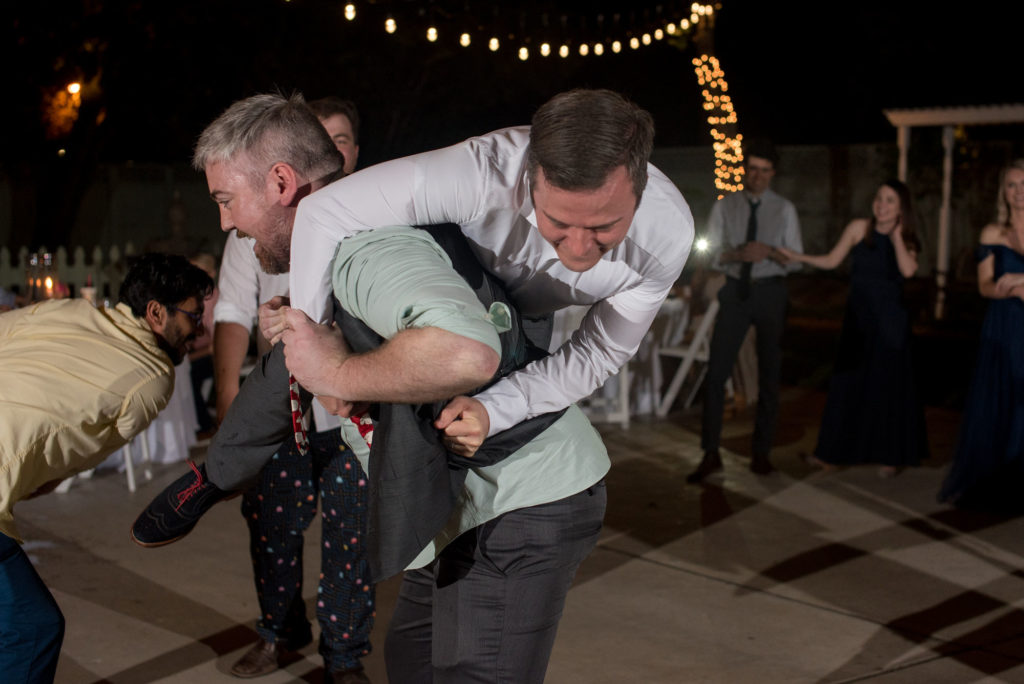 groom lifted up during reception