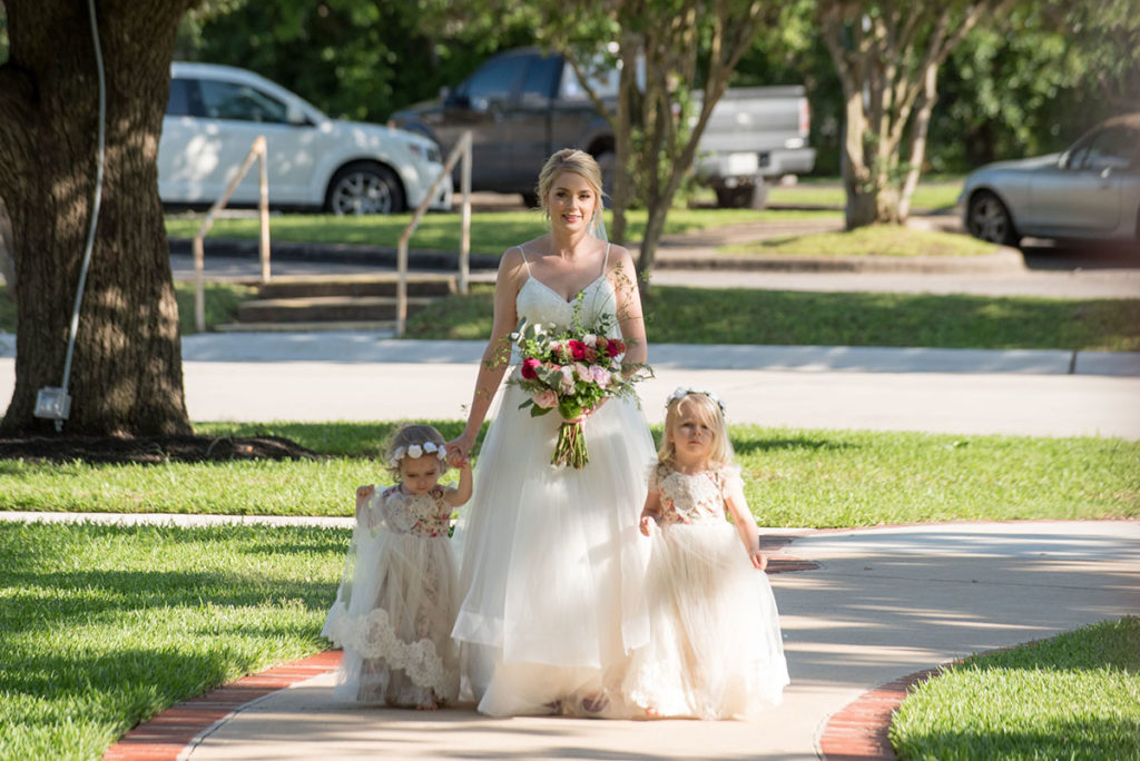 bride and daughters walking the aisle for the ceremony