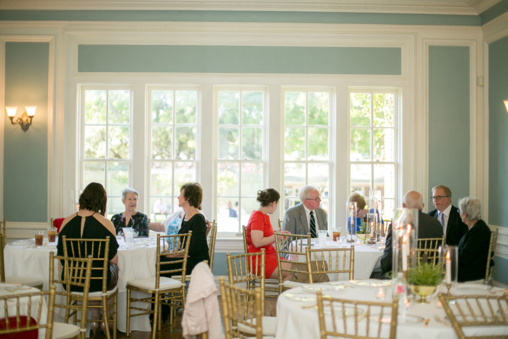 wedding reception table filled with guests in the blue room at the Astin Mansion