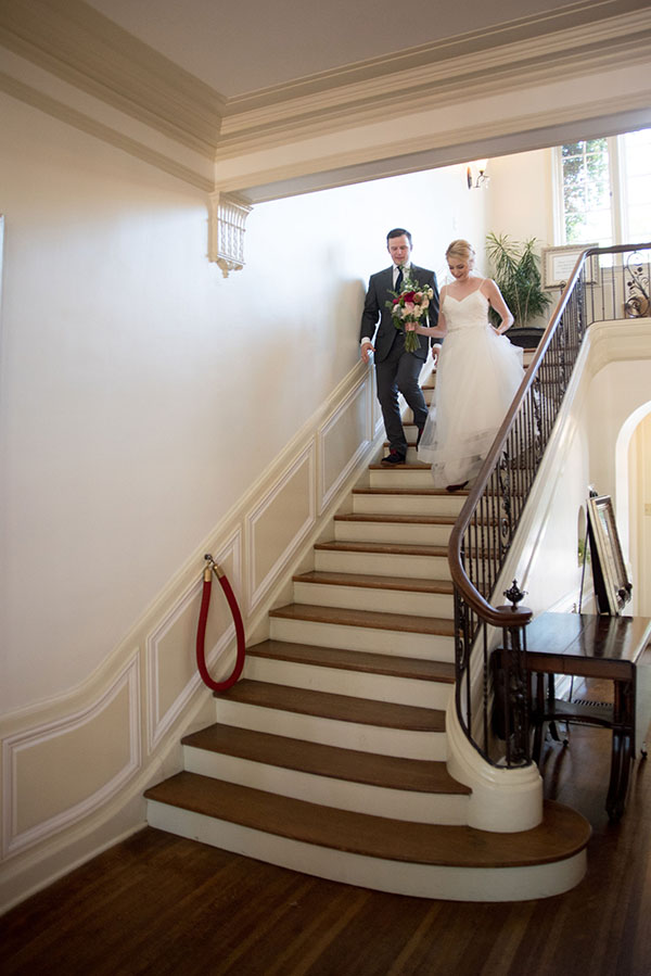 bride and groom descending stairs to enter the reception 