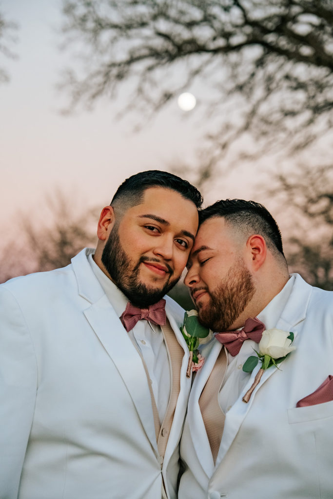 LGBTQ Wedding Houston grooms sweetly caress under the evening moon