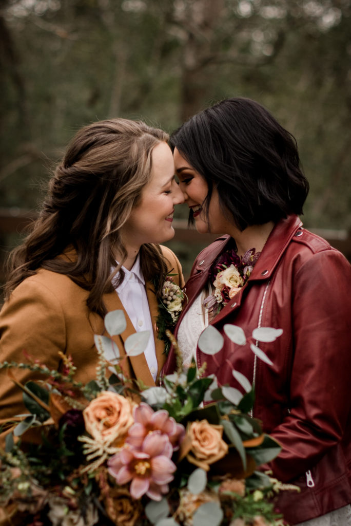 LGBTQ Wedding Houston brides in leather jackets with bouquet